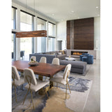 Aeris Linear Pendant by Cerno in walnut over a dining table in an open living room