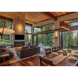 Aeris Linear Pendant by Cerno in walnut over a dining table in a mountain home