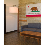 Altus Floor Lamp by Cerno in a living room with a reclaimed wood wall