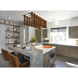 Arca Linear Pendant by Cerno in walnut hanging over a kitchen island