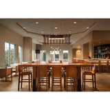 Arca Linear Pendants by Cerno in walnut over a communal table in a hotel lobby