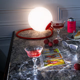 Bolleke Hanging Lamp - Red, lit on a kitchen counter