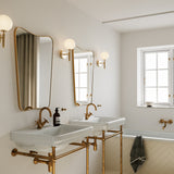 Brass/Opal Miira Wall Sconce by Nuura in Bathroom
