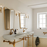 Brass/Optic Clear Miira Wall Sconce by Nuura in Bathroom