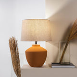 Buriti Table Lamp by Geo Contemporary in Terracotta with a Rustic Linen shade on a console