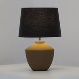 Buriti Table Lamp by Geo Contemporary in Sand with a Black shade, lit