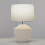 Buriti Table Lamp by Geo Contemporary in White with a White shade, lit