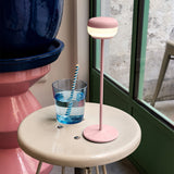 Cheerio Table Lamp - Soft Pink, on a side table by a window