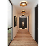Casia Flushmounts by Cerno lifestyle - distressed brass flush mounts along a hallway