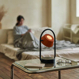 Coral Orange Olo Ring Portable Table Lamp by Seed Design in Bedroom