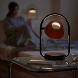 Coral Orange Olo Ring Portable Table Lamp by Seed Design in Bedroom