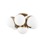 Cupertino Semi Flush by Troy Lighting in Patina Brass, seven opal-white glass globes in a brass cradle
