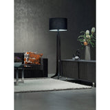 Forma Floor Lamp by Cerno with a black shade in a dark modern living room