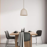 Gael Ceramic Pendant Light by Geo Contemporary in White hanging over a wooden dining table with charcoal chairs