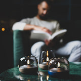 Glow 10 Candle Holder - lit on a marble coffee table