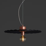 Guanabara Pendant Light by Geo Contemporary in Black with copper fittings, lit against a charcoal studio backdrop