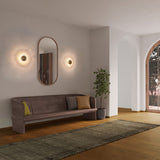 Inviso Wall Sconces by Cerno flanking a mirror in a living room
