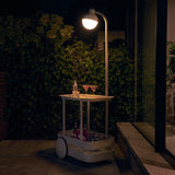 Jolly Trolley Lighted Bar Cart - Light Grey, lit on a terrace at night