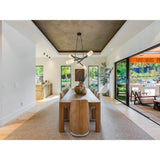 Locus Chandelier by Cerno in dark stained walnut with black accents above a long dining table