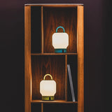 Loome Battery Table Lamp - Moss and Smoky Teal, in a bookcase