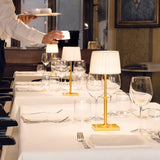 Matte Gold Poldina Classic Portable Table Lamp by Zafferano in Restaurant