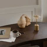 Nordic Gold/Clear Blossi Mini Portable Table Lamp by Nuura in Study Room