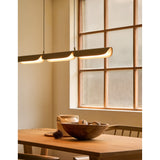 Oatmeal Flo PL3 Linear Suspension by Seed Design in Dining Area