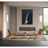 Ora Wall Sconce by Cerno flanking a fireplace in a modern living room