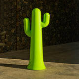 Pancho Floor Lamp - Lime With Cable, against a stone wall