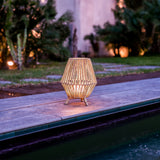 Sisine Table Lamp - lit by a pool