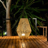 Sisine Floor Lamp - lit on a deck