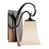 Scroll Wall Sconce, shown in Natural Iron, by Hubbardton Forge
