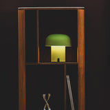 Sensa Battery Table Lamp - Moss, in a bookcase