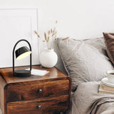 Shiny Black Olo Ring Portable Table Lamp by Seed Design in Bedroom