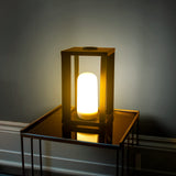 Siroco Portable Lantern - Small, lit on a side table