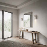 Spero Wall Sconces by Cerno flanking a mirror above an entryway console