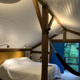 Sunset Ceramic Pendant Light by Geo Contemporary in White in an attic bedroom with exposed timber beams