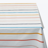 Cotton tablecloth in horizontal multicolour stripes of blue, red, mustard and grey on white — Basil Bangs Tablecloth by Basil Bangs