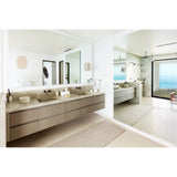 Tempus Wall Sconces by Cerno beside a bathroom vanity mirror