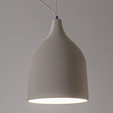 Trento Ceramic Pendant Light by Geo Contemporary in White, lit, seen close against a grey studio wall