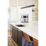 Una Linear Pendant by Cerno in dark stained walnut over a marble kitchen island