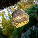 Conta Portable Pendant Light - Taupe, lit in a garden