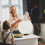 Sphere Battery Wine Cooler Lamp - Brass, chilling a bottle in the kitchen