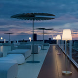 Lola Slim Solar Floor Lamp - on a rooftop terrace at dusk