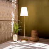 Lola Slim Floor Lamp - Brass, in a sunlit room