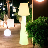 Lola Floor Lamp - 3000K, lit on a terrace at night