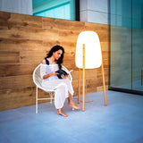 Rocket Floor Lamp - Large, beside a reader on a patio