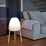 Rocket Floor Lamp - Small, lit beside a sofa