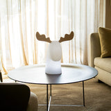 Rudy Reindeer Table Lamp - Plug In, on a round coffee table