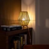 Sisine Table Lamp - Indoor Only, lit on a shelf